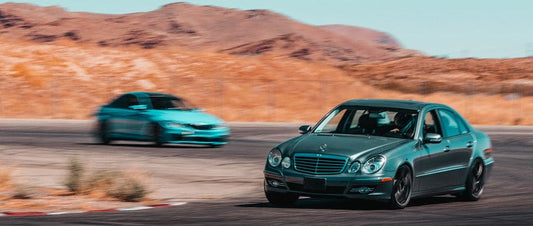 Mercedes-Benz W211 E350 sleeper build on track, cornering at speed during track-day at Willow Springs International Raceway
