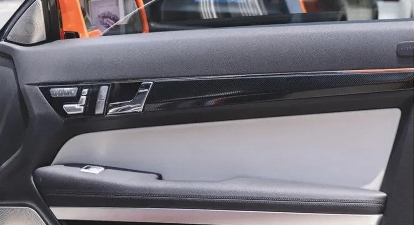 Installed carbon fiber style door handle panel trim strips in Mercedes E-Class C207 Coupe