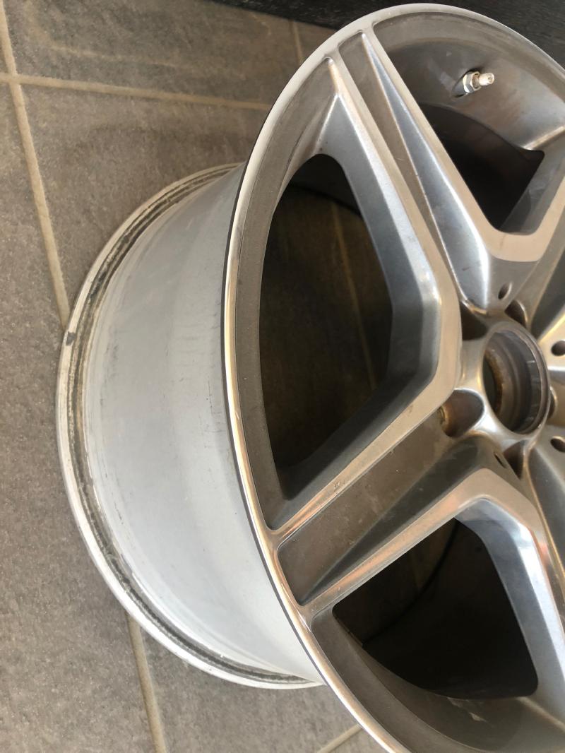 Rear angle view of OEM 18x9 C63 AMG wheel with machined charcoal finish