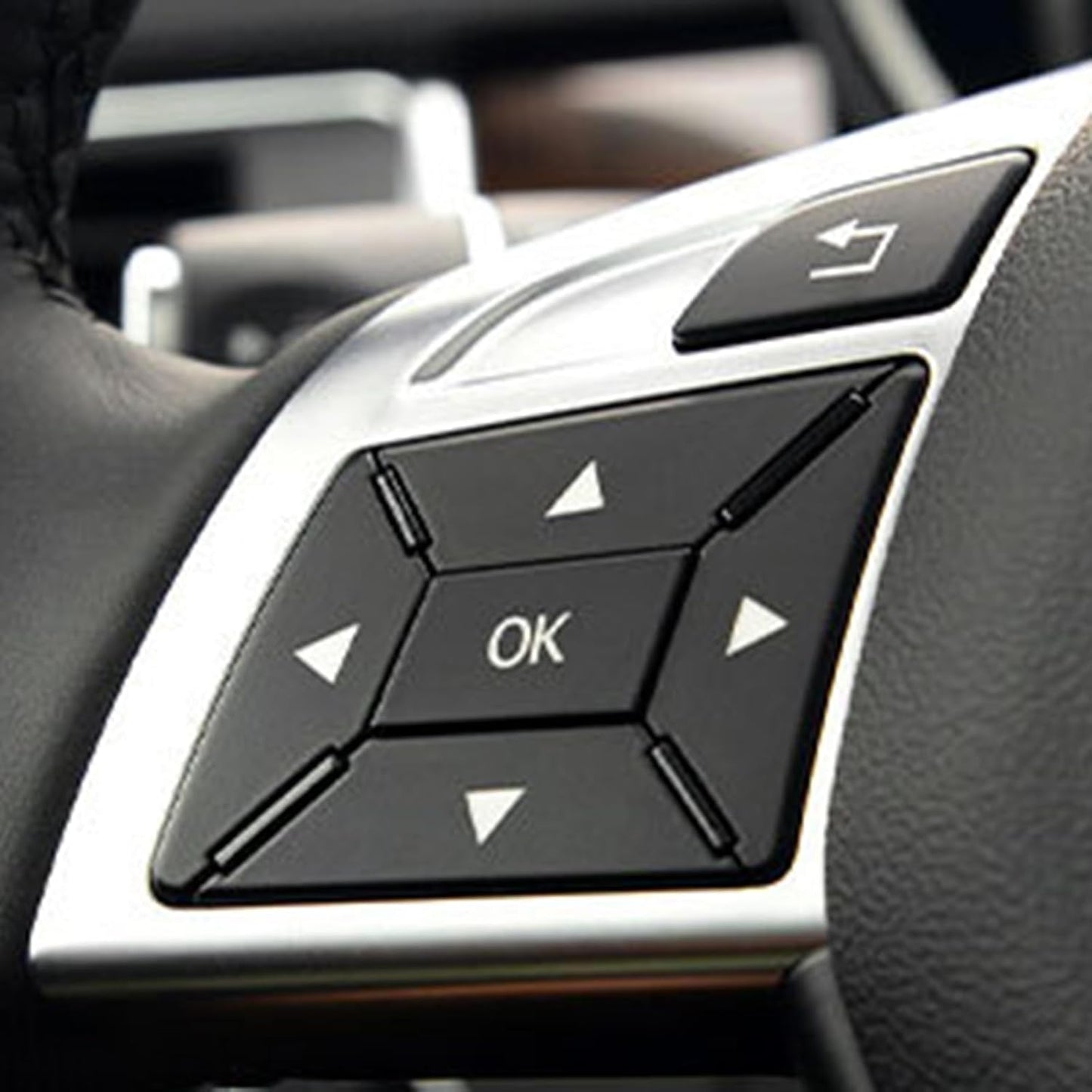 Close-up of Mercedes steering wheel trim with OK and arrow buttons installed