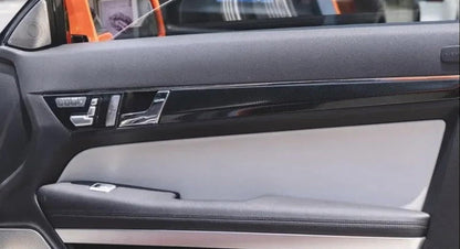 Installed carbon fiber style door handle panel trim strips in Mercedes E-Class C207 Coupe