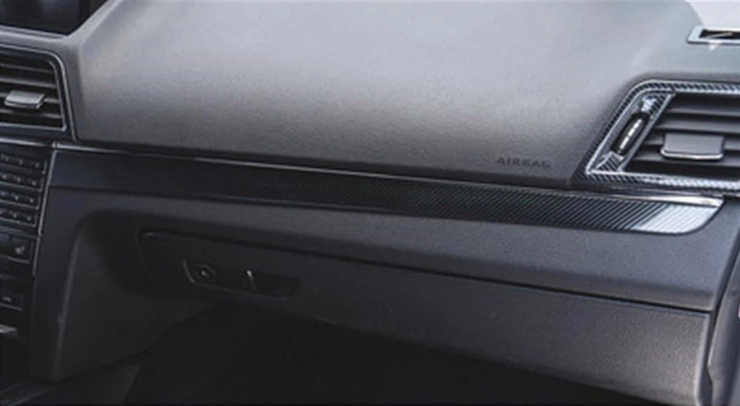 Installed carbon fiber-style glove box trim on 2009–2015 Mercedes E-Class Coupe dashboard