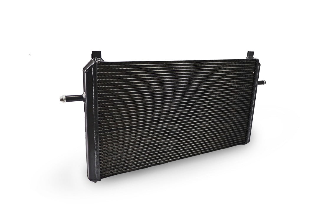 A black front mount heat exchanger for Mercedes CLA45 AMG cooling upgrade, with a ribbed surface and metal construction.