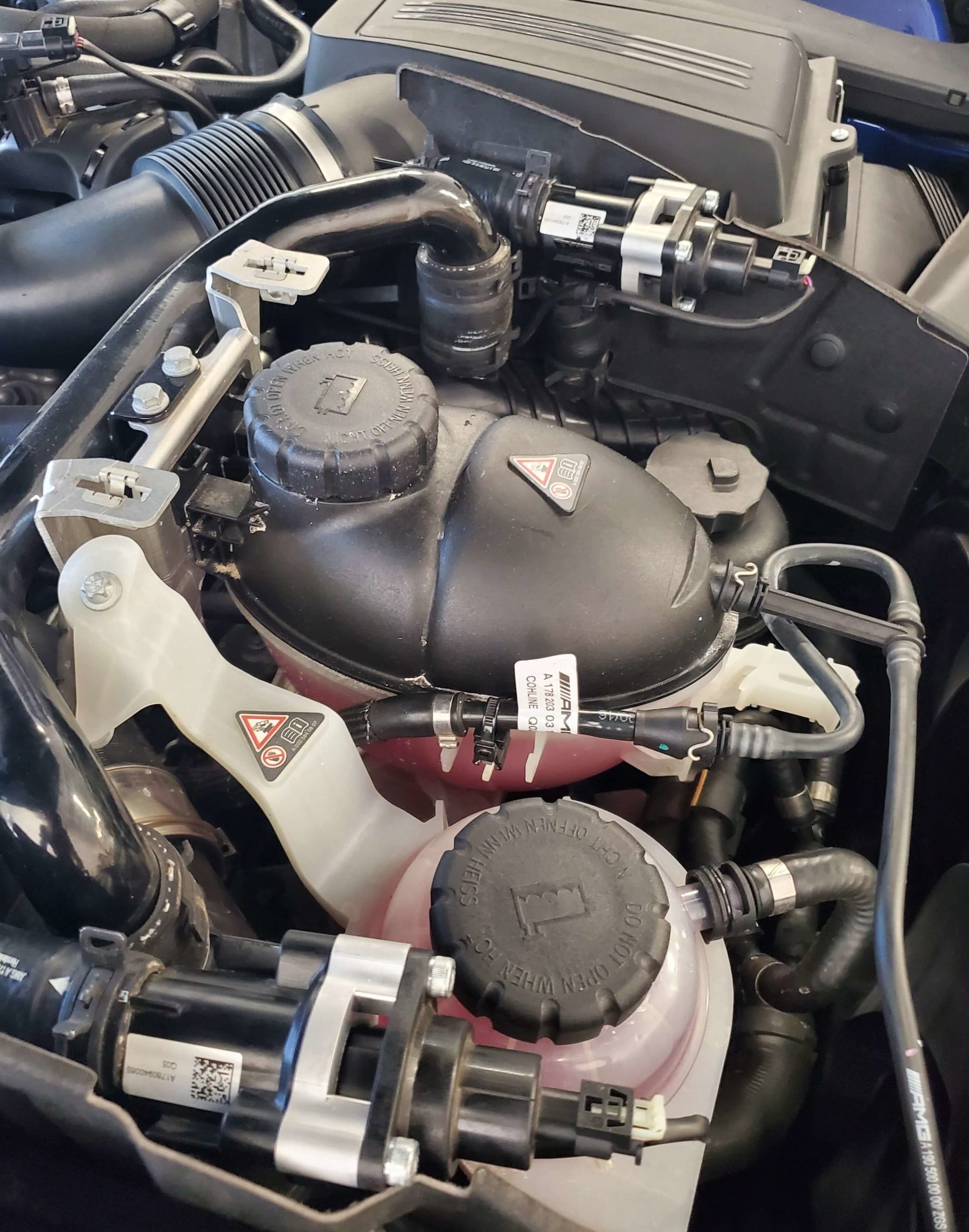Mercedes-AMG E63 engine bay showing M177 twin-turbo layout for blow-off valve VTA adapter installation