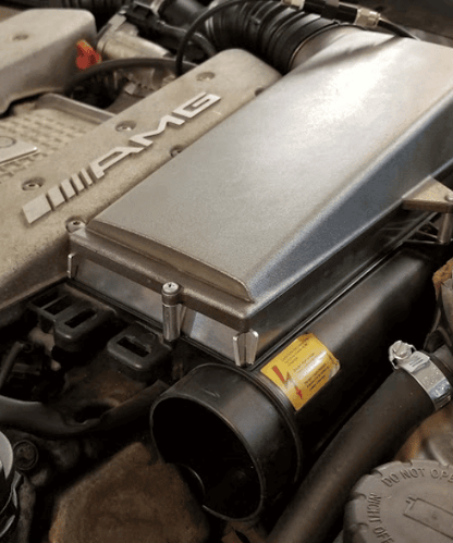 Mercedes AMG M113K intake filter spacer mounted on supercharged E55 AMG intake assembly