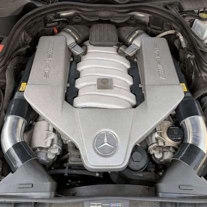 Pair of aluminum intake tubes for Mercedes-Benz 63 AMG M156 engine, showing full performance upgrade kit with couplers and adapters