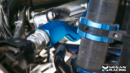 Installed Megan Racing blue rear upper camber arms on Mercedes C-Class W206 2021+ suspension, showing mounted position with hardened rubber bushings and adjustable turnbuckle for camber correction