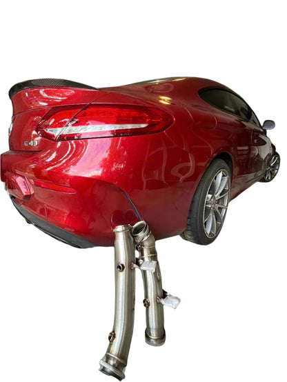 Stainless steel downpipes shown next to Mercedes AMG vehicle for visual reference