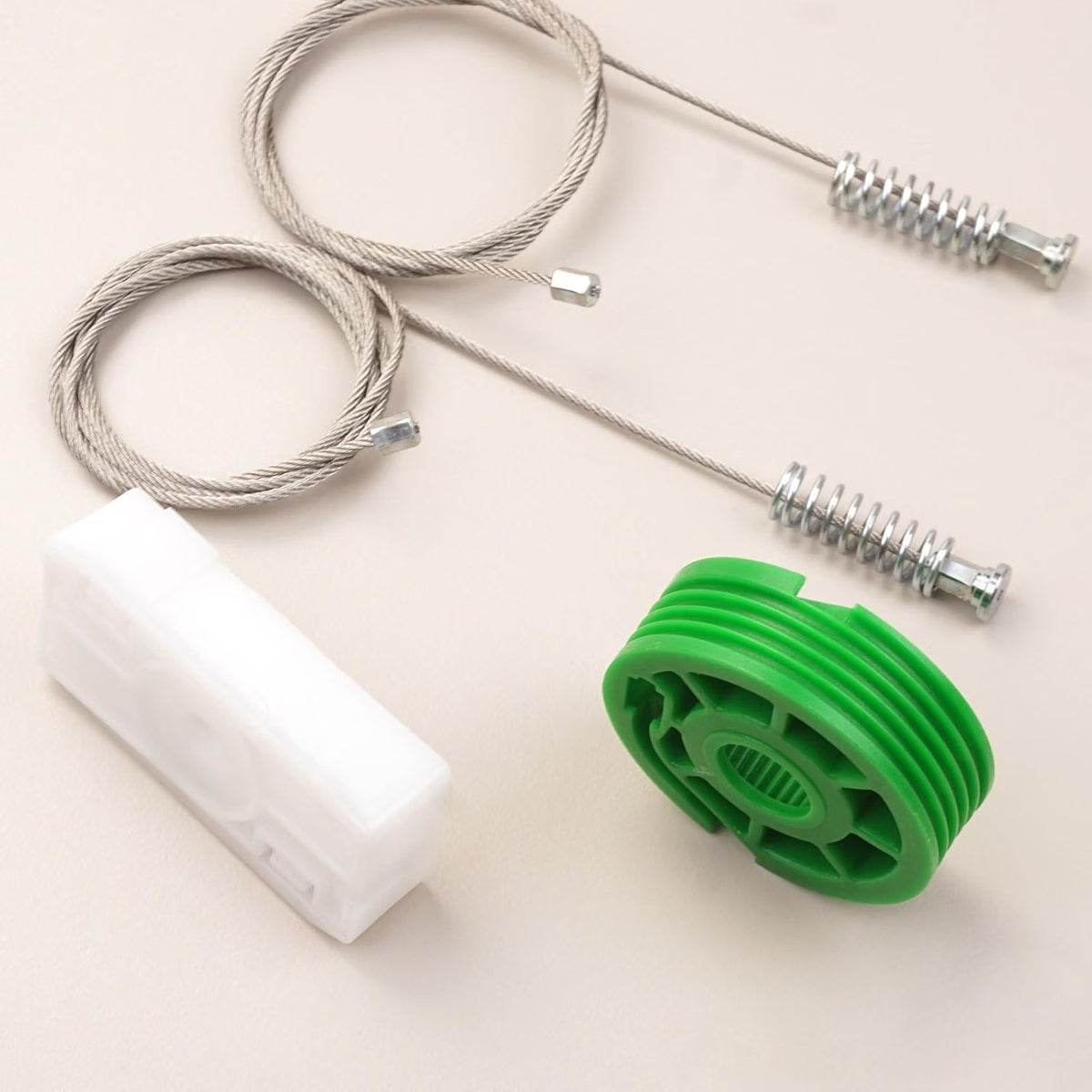 Mercedes-Benz CLK cabriolet rear quarter window regulator repair kit parts laid out — cable, white carrier and green pulley