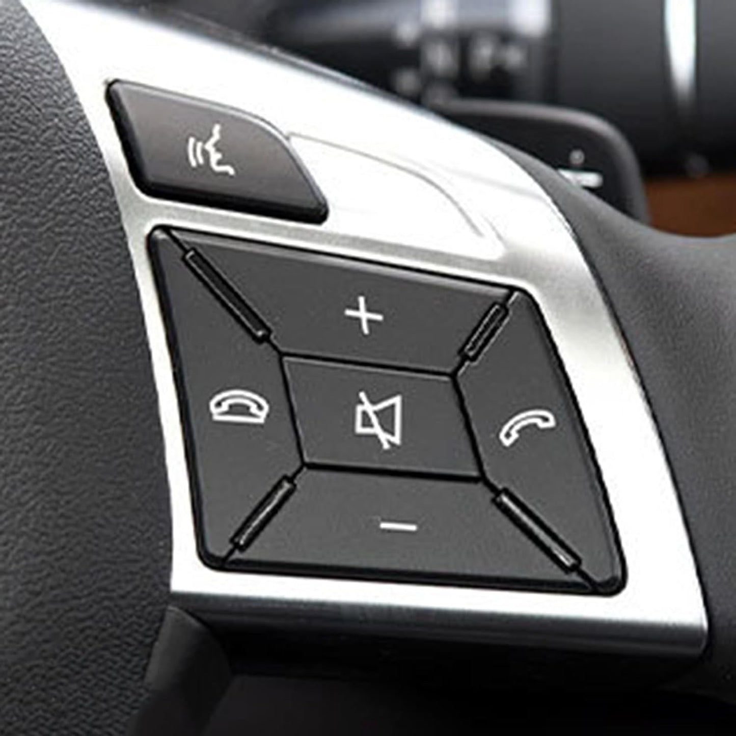 Close-up of Mercedes steering wheel with volume and call trim installed