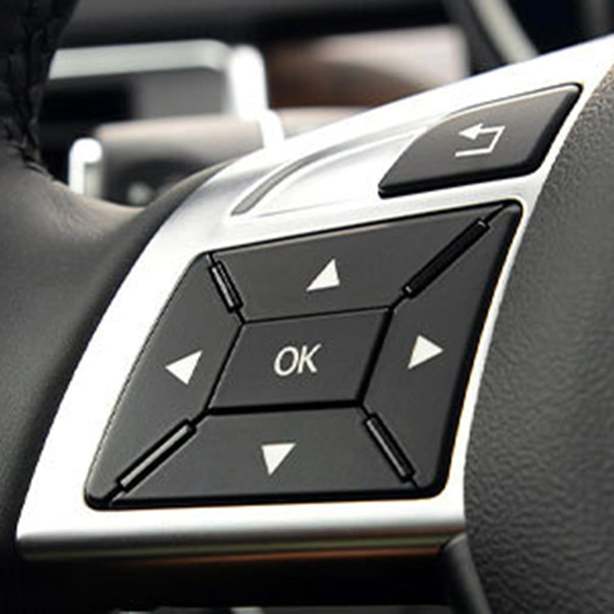 Close-up of black overlays installed on the left-hand arrow and OK controls
