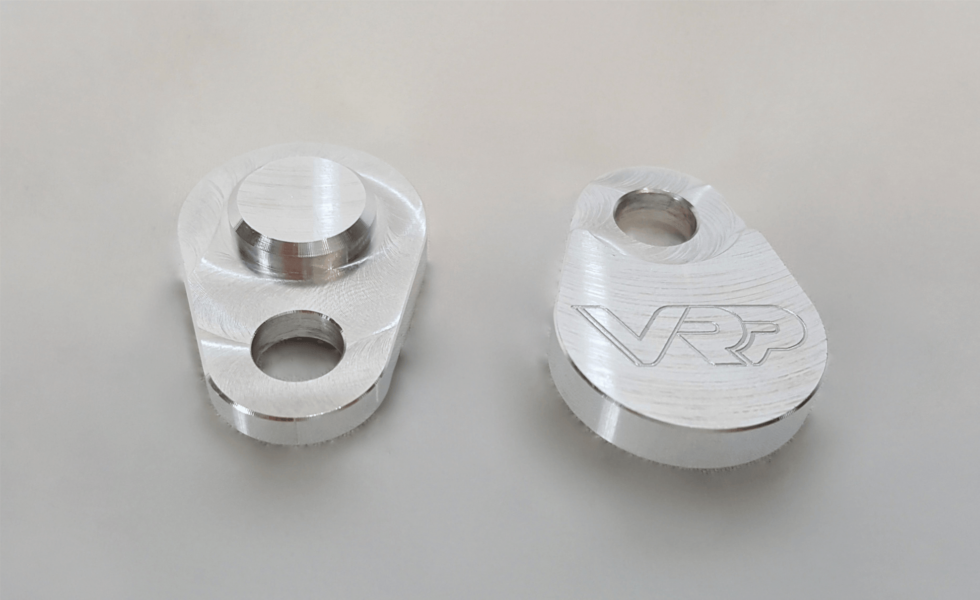Angled view of BenzUnited billet SAI block-off plates with VRP logo engraving – made in USA.