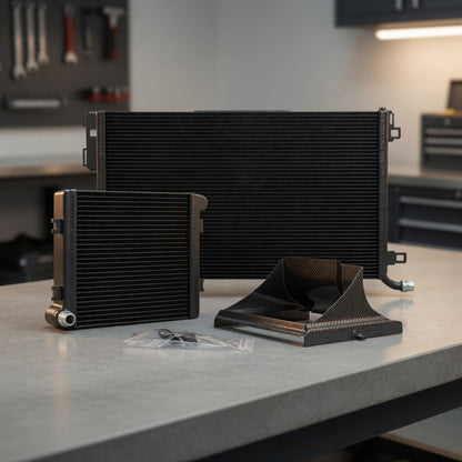 Close-up arrangement of W205 C63 front mount radiator, auxiliary heat exchanger, and carbon fiber air baffles