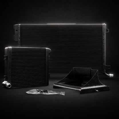 Premium dark background product shot of W205 C63 / C63S Front Mount + Auxiliary Heat Exchanger Bundle with carbon parts