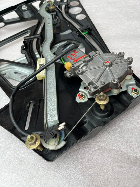 Close-up showing window motor, cable track, and pulleys on W208 regulator